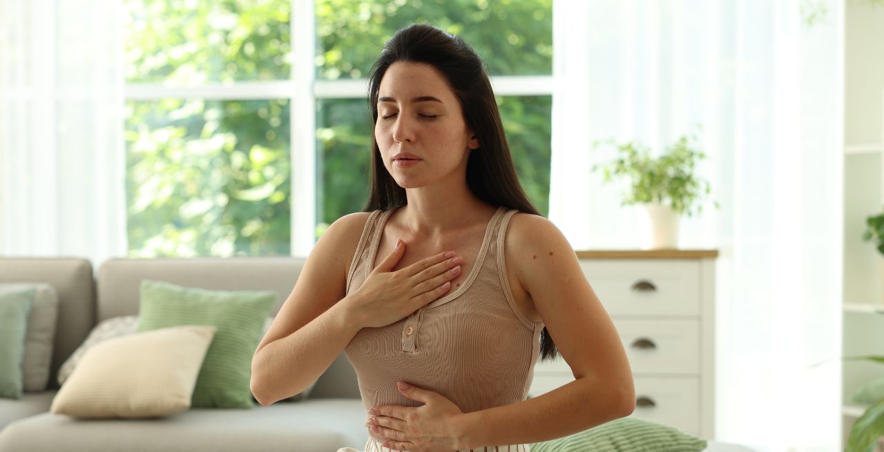 Woman showing signs of stress or anxiety with her hand over her chest