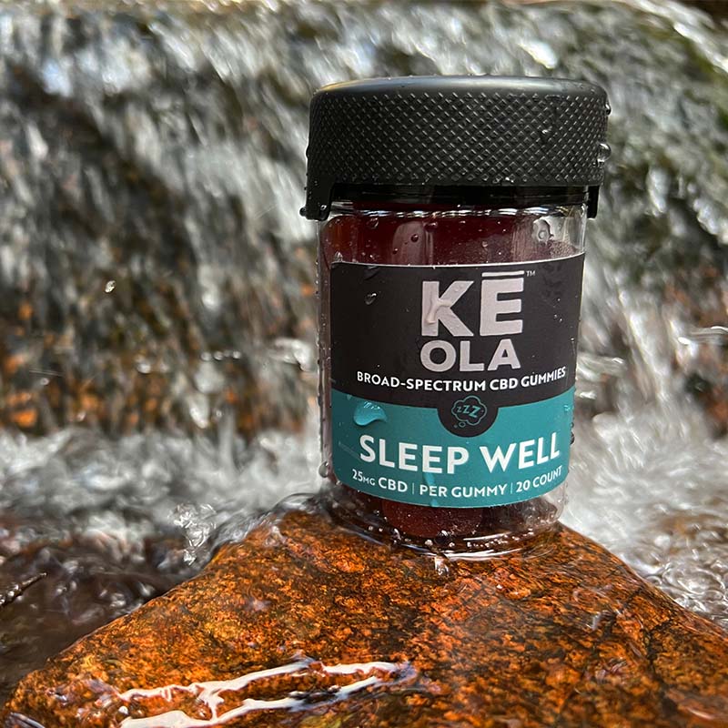Keola Sleep Well Gummies on a rock near a stream