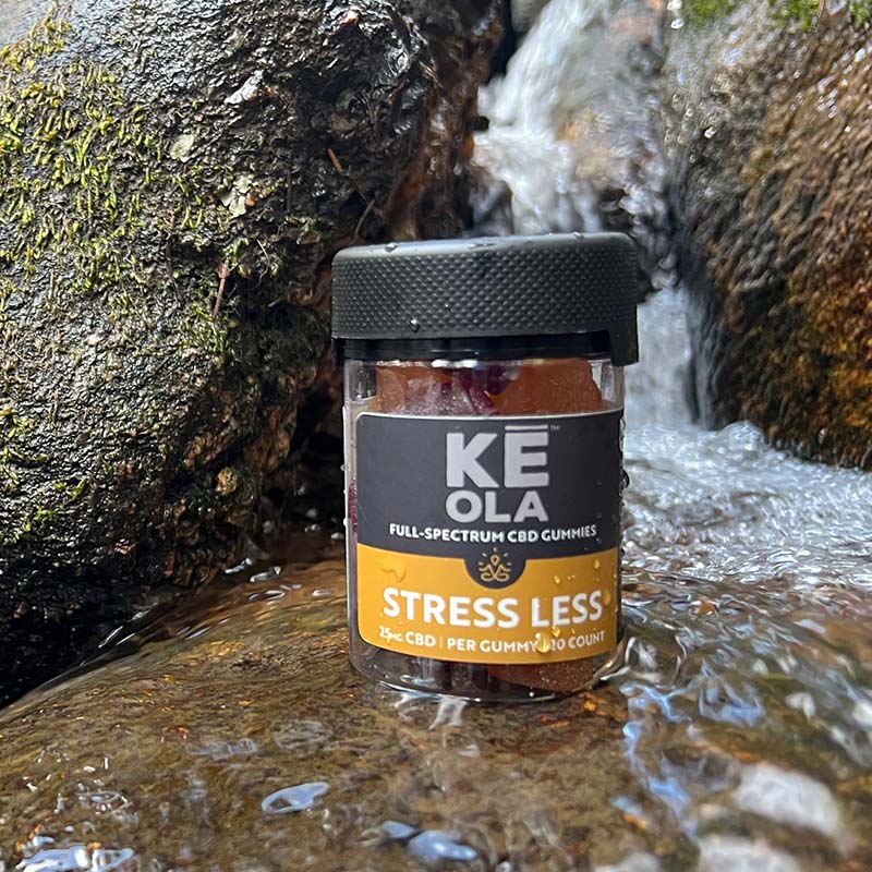 Keola Stress Less Gummies on a rock near a stream
